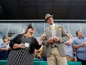 Carla, left, and Steve Hunt look on during a Canadian Derby race at Northlands Park in Edmonton on Saturday.