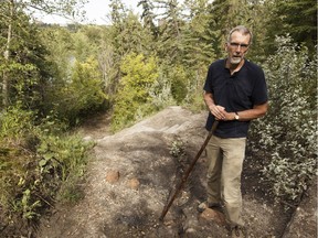 Glen Argan stands near a destroyed trail in the river valley in Forest Heights Park in Edmonton, Alberta on Thursday, August 11, 2016. Argan said the path has been in bad condition for years, and argues the city should repair it.