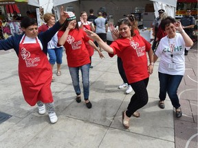 Vendors break out in the Dabka dance during the Lebanese Festival in Churchill Square in Edmonton on Aug. 20, 2105.