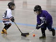 Tolbin Gossell (L) and Gavin Annett battle for the ball during a pre-novice ball hockey game at the North East Soccer Centre Jan. 3, 2015.