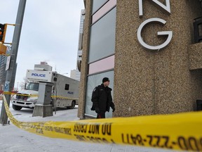 Police investigate at the downtown parkade where Arnold Marshall Rae was found beaten to death in 2013. Three men later pleaded guilty of manslaughter in connection with Rae's death.