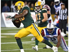 Edmonton Eskimos Deon Lacey (40) makes an interception and runs for a TD with under one minute left to play as Montreal Alouettes Nik Lewis (8) makes a diving effort during CFL action at Commonwealth Stadium in Edmonton Friday, August 11, 2016.