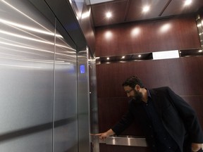 Reporter Juris Graney checks out the new elevators at Commerce Place in Edmonton, on Monday, Aug. 22, 2016.