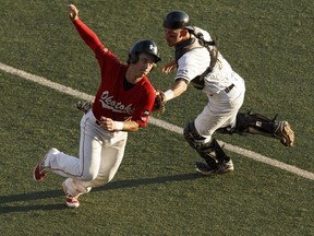 Edmonton's Logan Wedgwood (right) tags out Okotoks' Drake Kirkwood during Game 4 of the Western Major Baseball League playoff series between the Edmonton Prospects and the Okotoks Dawgs at Telus Field in Edmonton on August 3, 2016.