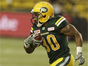 Edmonton's John White (30) runs the ball during the first half of a CFL football game between the Edmonton Eskimos and the Winnipeg Blue Bombers at Commonwealth Stadium in Edmonton, on July 28, 2016.