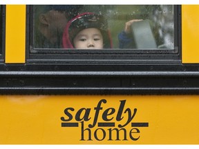 Hugo Wu, 5, peers out of a school bus window during an event at Northlands by The First Rider program in Edmonton August 23, 2016.