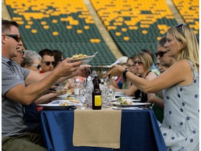About 400 people enjoy dinner at Commonwealth stadium during Feast on the Field in Edmonton on Aug. 17, 2016.