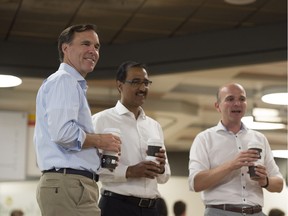 Federal Finance Minister Bill Morneau (left) handed out coffee at Burrow Café with Infrastructure Minister Amarjeet Sohi, and Randy Boissonnault, member of Parliament for Edmonton Centre, on Wednesday Aug. 17, 2016.