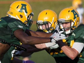 (left to right) Shaydon Phillip (11) and Ryan Migadel (24) take part in an Alberta Golden Bears football camp practice at Foote Field, in Edmonton on Monday Aug. 15, 2016. Photo by David Bloom Photos off Alberta Golden Bears football camp for Jason Hills story slated to run in Wednesday, Aug. 17 editions.