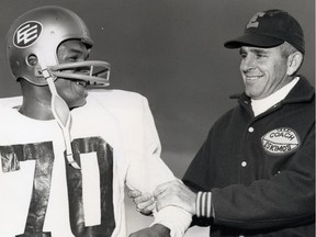 Edmonton Eskimos head coach Neill Armstrong, right, clamps a firm grip on highly touted newcomer Mel Anthony on Sept. 3, 1965.