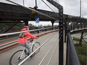 A cyclist rides across the High Level Bridge, in Edmonton on Tuesday Aug. 9, 2016.
