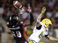 Ottawa Redblacks defensive back Imoan Claiborne, left, blocks Edmonton Eskimos receiver Chris Getzlaf during CFL action on Aug. 6, 2016 in Ottawa.