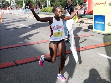 Jane Murage of Kenya wins the women's half-marathon in Edmonton on Sunday, Aug. 21, 2016.