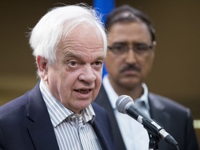 Immigration Minister John McCallum speaks to the media following a roundtable discussion with local organizations on Thursday, Aug. 18, 2016 in Edmonton while Infrastructure Minister Amarjeet Sohi listens.