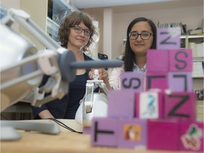 Kim Adams, left, and Alejandra Ruiz at the University of Alberta are testing how robots can help children with physical disabilities.
