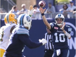 Toronto Argonauts quarterback Logan Kilgore, right, throws a pass against the Edmonton Eskimos during first half CFL football action in Toronto on Saturday, August 20, 2016.