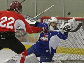 Lucas Foley (left) looks for a rebound as goalie Carter Phair (right) makes a save during an Edmonton Oil Kings training camp scrimmage game at the Dow Centennial Centre in Fort Saskatchewan, Alberta on Monday August 29, 2016.