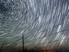 Meteors streak above the Wyoming countryside in this time-elapsed photo of the Persieds meteor shower.