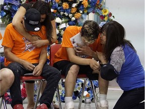 Mourners grieve at the funeral for Dylan Laboucan, 17, and Cory Grey, 19, two Whitefish River First Nations teens who were found dead in July 2016 near the Atikameg settlement in northern Alberta. The funeral was held Friday Aug. 5, 2016.