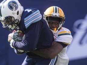 Toronto Argonauts running back Anthony Coombs, left, is tackled by Edmonton Eskimos cornerback Patrick Watkins during first half CFL football action in Toronto on Saturday, August 20, 2016.
