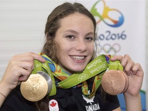 Canada's Penny Oleksiak holds up her four medals, a gold, silver and two bronze, she won at the 2016 Summer Olympics in Rio de Janeiro, Brazil.