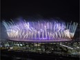 People watch from the Mangueira slum fireworks exploding above the Maracana stadium during the closing ceremony for the Summer Olympics in Rio de Janeiro, Brazil, Sunday, Aug. 21, 2016.