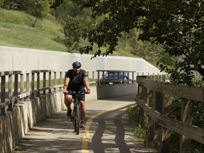 A cyclist rides along River Valley Road. The area is slated for a potential development to bring Edmontonians closer to the North Saskatchewan River.
