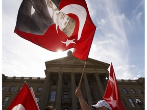 Demonstrators wave Turkish flags during a pro-democracy demonstration by Edmonton's Turkish community at the Alberta legislature in Edmonton on Sunday, August 14, 2016.