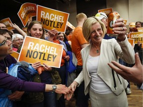 Alberta NDP Leader Rachel Notley holds a can of orange Crush soda pop as she enters a campaign rally in Calgary, Alta., Saturday, May 2, 2015.