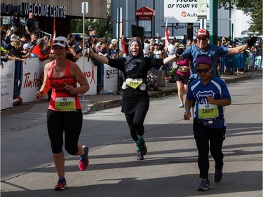 Runners cross the finish line of the Edmonton Marathon on Sunday, Aug. 21, 2016.
