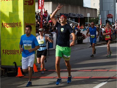 Runners cross the finish line during the Edmonton Marathon on Sunday, Aug. 21, 2016.