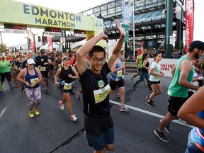 Runners leave the start line of the half-marathon in Edmonton, Alta., on Sunday, Aug. 21, 2016.
