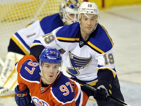 EDMONTON , AB - OCTOBER 15:  Connor McDavid #97 of the Edmonton Oilers is checked by Jay Bouwmeester #19 of the St. Louis Blues at Rexall Place on October 15, 2015 in Edmonton, Alberta, Canada.(Photo by Dan Riedlhuber/Getty Images)