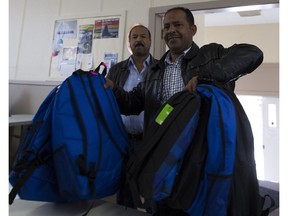 Syrian refugee Mohad El-Mohamad picks up backpacks Thursday for his four sons and one daughter at the Salvation Army Crossroads Community Church. It gave out more than 700 new backpacks filled with school supplies for children in need.