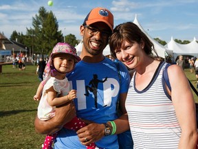 Ten-month-old Waverley Pinto, left, with parents Sheldon and Alys Pinto during the Edmonton Folk Music Festival.