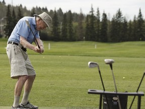 Brian Sproule hits the driving range with his friends Doug MacDougall and Moe Handford at Royal Mayfair Golf Club in Edmonton on July 19, 2016.