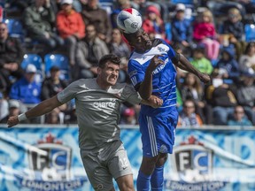 Tom Ameobi of FC Edmonton, gets a touch on the ball before Ramon Martin Del Campo of Puerto Rico FC at Clark Field. The two NASL teams played to a 0-0 draw on August. 28, 2016.  Photo by Shaughn Butts / Postmedia  Derek VanDiest Story Photos off FC Edmonton game for story running in print Monday, Aug. 29.