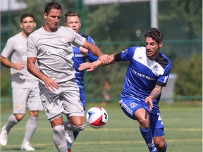 FC Edmonton midfielder Nicolas Di Biase, right, challenges Puerto Rico FC forward Pedro Mendes for the ball in North American Soccer League play at Clarke Stadium on Aug. 28, 2016.