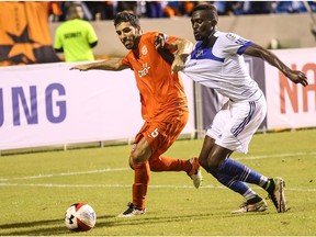 FC Edmonton striker Tomi Ameobi, right, battles for the ball with Puerto Rico FC defender Ramon Soria in North American Soccer League play Saturday, Aug. 6, 2016 in Puerto Rico. Ameobi scored the only goal of the game in a 1-0 win for FC Edmonton.