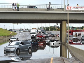 Vehicles and people were flooded under the 106 Street overpass on Whitemud Drive and had to be rescued by the fire department in Edmonton on Wednesday, July 27, 2016.