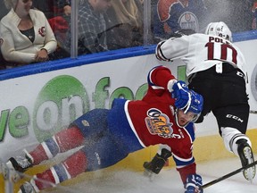 Edmonton Oil Kings Aaron Irving (24) and Red Deer Rebels Evan Polei (10) crash into the boards in WHL action at Rogers Place, the first-ever hockey game in the new arena in Edmonton Saturday, September 24, 2016.