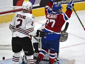 Edmonton Oil Kings Trey Fix-Wolansky (27) celebrates Tyler Robertson's goal on Red Deer Rebels goalie Trevor Martin (35) in WHL action at Rogers Place, the first-ever hockey game in the new arena in Edmonton Saturday, September 24, 2016.