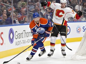 Calgary Flames ' Mark Jankowski (77) chases Edmonton Oilers' Kris Versteeg (13) during first period NHL pre-season action, in Edmonton on Monday September 26, 2016.