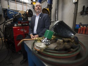 NAIT School of Skilled Trades Dean Malcolm Haines poses for a photo in a student welding booth, in Edmonton on Wednesday Sept. 28, 2016.