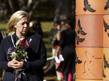 Widow Shelly MacInnis-Wynn reads the names of the fallen on the Pillar of Strength at the end of Alberta's Police and Peace Officers' Memorial Day at the Alberta Legislature in Edmonton on Sunday, September 25, 2016. Her husband David Wynn was shot in the line of duty in Jan. 2015.