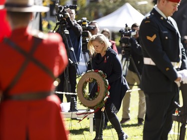 Widow Shelly MacInnis-Wynn lays a wreath for the families of fallen officers during Alberta's Police and Peace Officers' Memorial Day at the Alberta Legislature in Edmonton on September 25, 2016. Her husband David Wynn was shot in the line of duty in Jan. 2015