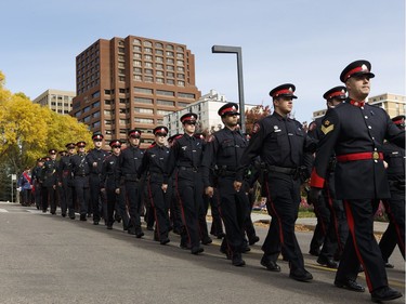 Calgary Police Service officers march during Alberta's Police and Peace Officers' Memorial Day at the Alberta Legislature in Edmonton on September 25, 2016.
