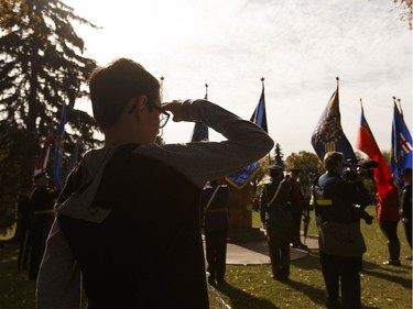 Conor Price, 12, salutes as the national anthem is played during Alberta's Police and Peace Officers' Memorial Day at the Alberta Legislature in Edmonton on Sunday, September 25, 2016.