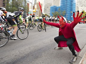 Robert Carroll, dressed as the devil, cheers for riders in the peloton during the final stage of the Tour of Alberta in Edmonton on Monday, September 5, 2016.