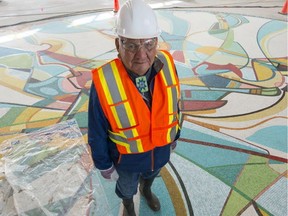 Alex Janvier standing on his artwork: Tsa Tsa Ke K'e (Iron Foot Place) in Ford Hall in Rogers Place (photo by Jeff Nash / Edmonton Oilers)